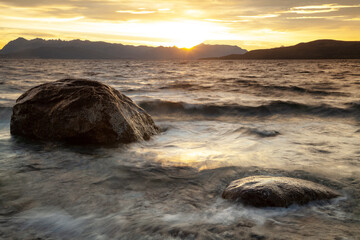 Beautiful sunset over the lake rocks mountains background. Patagonia Argentina. Hope concept