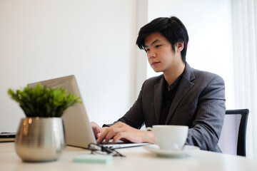 Businessman concentrate working with laptop in office.