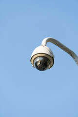 Outdoor CCTV security camera installed on pole in city.