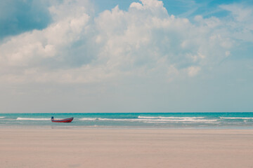 Boat anchored on a paradise beach.