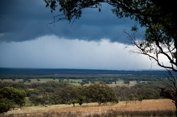 Dark storm clouds brew on the horizon of rural New South Wales Australia.
