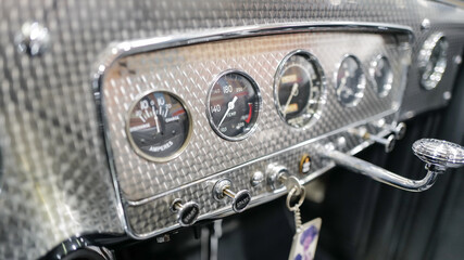 Vintage car interior dash and instruments and steering wheel