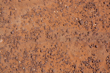 Texture of a reddish stone and background. Formations of rocks, backgrounds, patterns, textures.