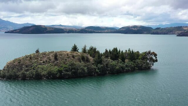 Drone Aerial View of Island in Laguna de Tota, Boyaca, Biggest Lake in Colombia. Alpine Water and Highland in Background