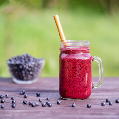 Smoothies from blueberry and banana in glass, close up
