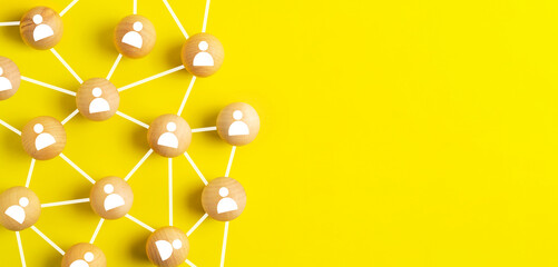 network and community concept,wooden ball connected together on yellow background