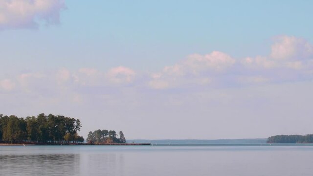lake scene with distant islands and cloudy blue sky