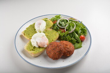 western luxury breakfast with avocado toast, boiled egg, smoked salmon fish, fried potato cake and salad halal breakfast menu 