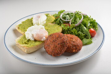 western luxury breakfast with avocado toast, boiled egg, smoked salmon fish, fried potato cake and salad halal breakfast menu 