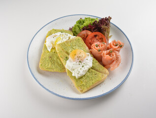 western luxury breakfast with avocado toast, boiled egg, smoked salmon fish, fried potato cake and salad halal breakfast menu 