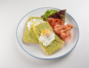 western luxury breakfast with avocado toast, boiled egg, smoked salmon fish, fried potato cake and salad halal breakfast menu 
