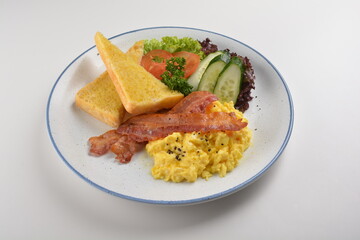 western big breakfast with butter toast, fried scramble egg, sausage, grill bacon, ham, omelette, bean and salad halal breakfast menu 