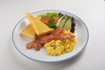 western big breakfast with butter toast, fried scramble egg, sausage, grill bacon, ham, omelette, bean and salad halal breakfast menu 