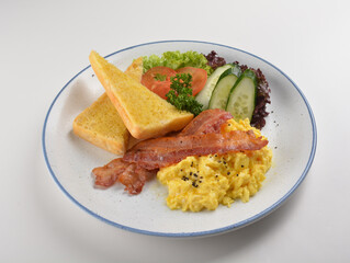western big breakfast with butter toast, fried scramble egg, sausage, grill bacon, ham, omelette, bean and salad halal breakfast menu 