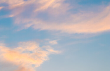 Naklejka na ściany i meble Background of blue sky with white and pink clouds in sunset
