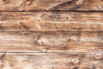 Very old, knotty boards on the wall.