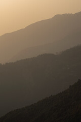 layers of mountain on a smoggy day during golden hour
