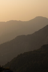 layers of mountain on a smoggy day during golden hour