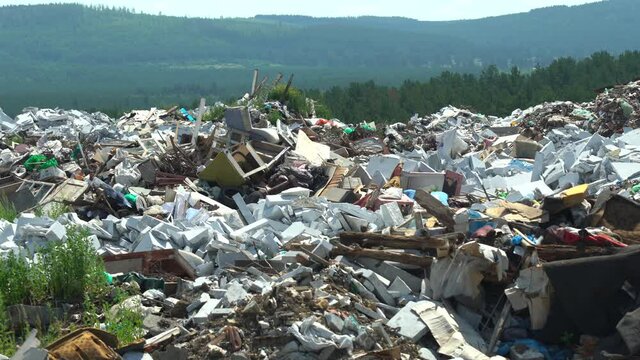 Waste dump in the forest. Stack of different types of large garbage dump, in environmental pollution concept