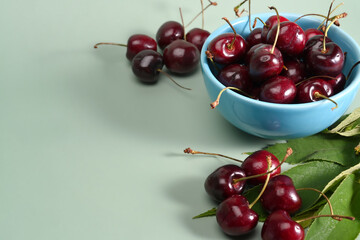 Obraz na płótnie Canvas Fresh cherry in a bowl on green background.