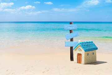 House on the beach with wooden sign, beach hosue for sale, summer holiday and vacation, holiday trip, accommodation in tropical island