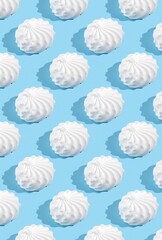 Pattern with white marshmallows on blue background.