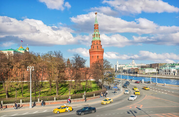 Fototapeta na wymiar Kremlin tower and taxi cars on the embankment in Moscow