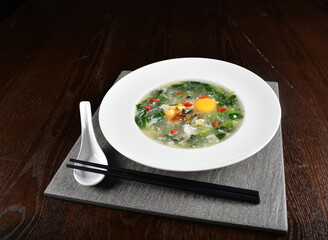 chinese wok fried water spinach vegetable with trio eggs century egg, salted egg, chicken egg and soup in dark background asian halal menu