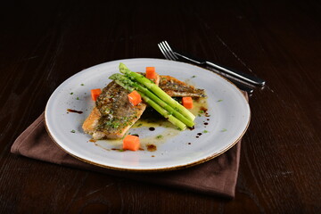 pan fried fresh grouper fish fillet seafood with asparagus and sauce main course in dark background western halal menu