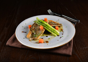 pan fried fresh grouper fish fillet seafood with asparagus and sauce main course in dark background western halal menu