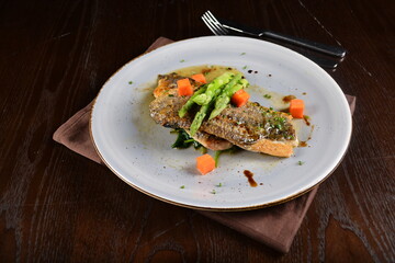 pan fried fresh grouper fish fillet seafood with asparagus and sauce main course in dark background western halal menu