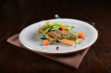 pan fried fresh grouper fish fillet seafood with asparagus and sauce main course in dark background western halal menu