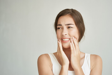 woman with toothache holding her face discomfort dentistry