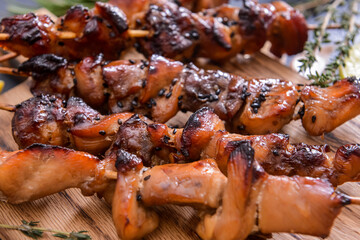 Board with tasty chicken kebab on table