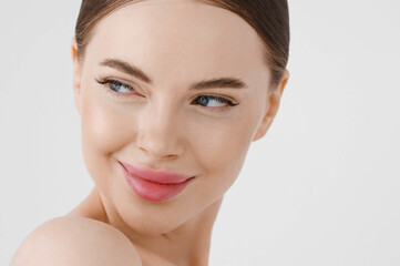 Beautiful woman face healthy skin natural make up lips close up blue eyes