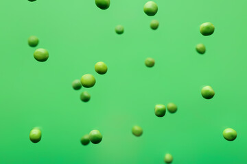 Flying peas on color background