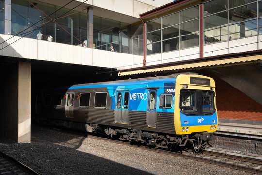 MELBOURNE, AUSTRALIA - February 15, 2014: Yellow blue Metro Train arrives at the Cranbourne station in Melbourne