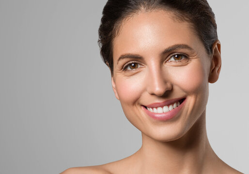 Beautiful healthy teerth smile woman brunette hair natural skin studio portrait