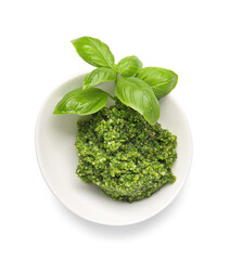 Bowl with fresh pesto sauce and basil leaves on white background