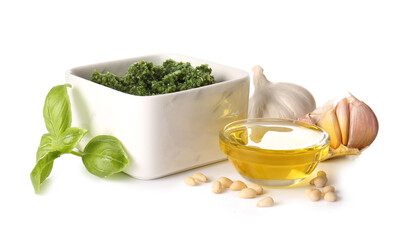 Bowl with fresh pesto sauce and ingredients on white background