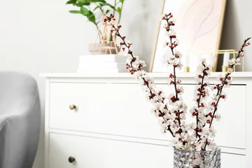 Fotobehang Vase with blooming spring branches in room © Pixel-Shot