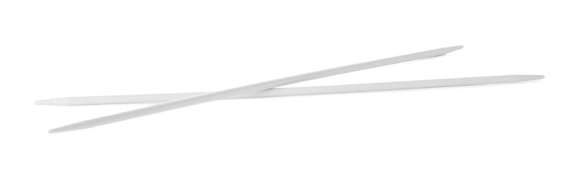 Knitting needles on white background