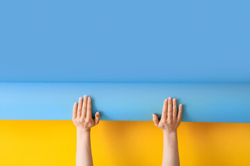 Female hands with blue and yellow wallpapers