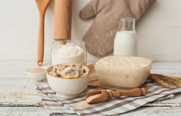 Composition with fresh and dry yeast on light wooden background
