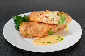 Puff pastry roll stuffed with salmon and broccoli
