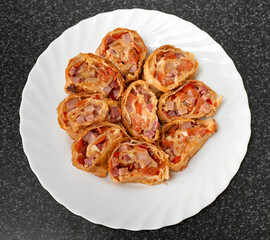 Puff pastry rolls stuffed with ham and red pepper. Top view