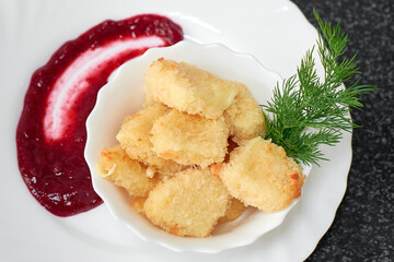 Crispy pieces of cheese fried in batter with sauce