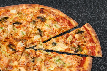 Sliced pizza with chicken, mushrooms and cheese
