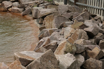 Piles of natural stones by the lake