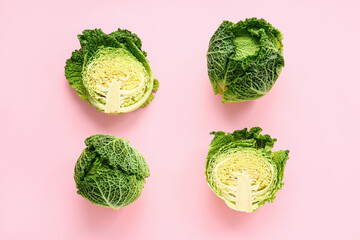 Pieces of fresh savoy cabbage on color background